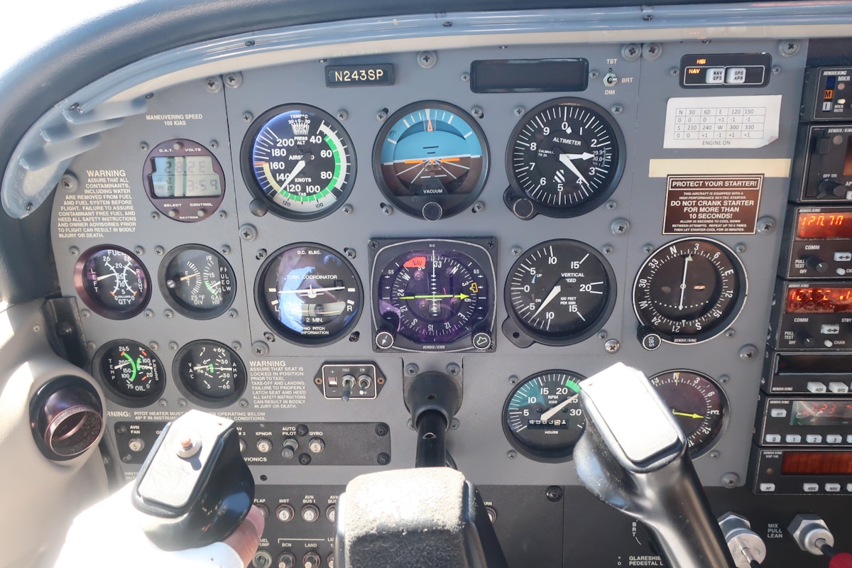 Analog flight instruments showing airspeed indicator, altimeter, and attitude indicator